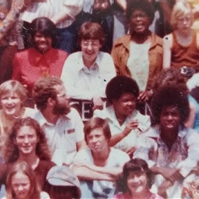 Kim Bowden-Kerby witting with a group of Baha'i friends